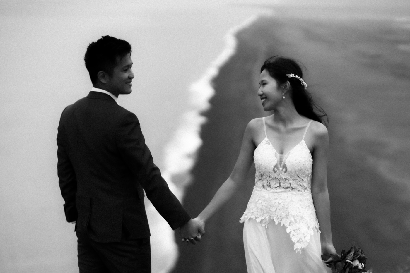 Iceland destination wedding photographer — couple on black sand beach