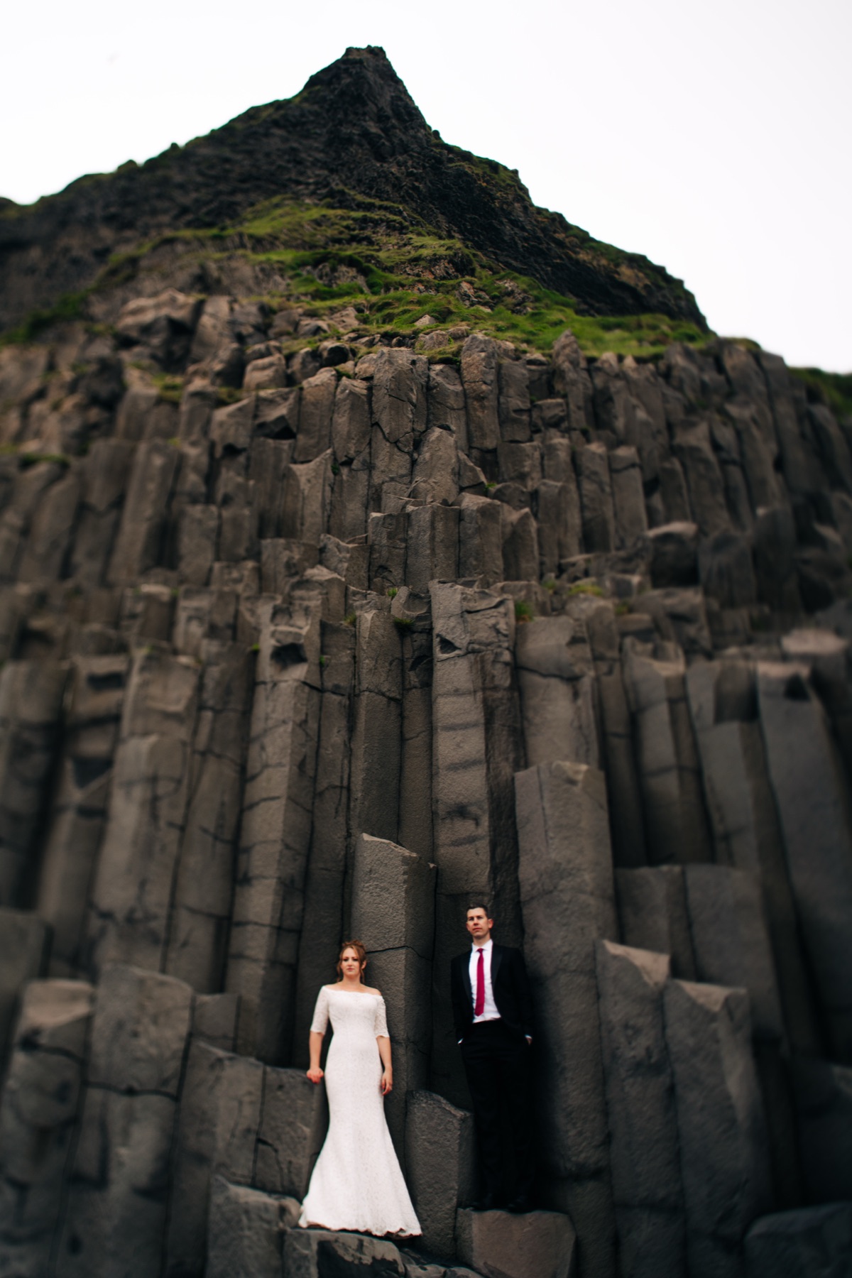 Iceland wedding photographer — couple at Reynisfjara black sand beach basalt columns